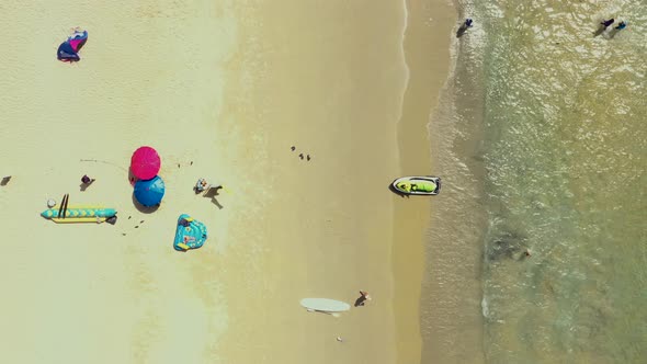 Aerial: Fly out from the beautiful beach. PHUKET, THAILAND Patong beach. sandy beach and blue transp