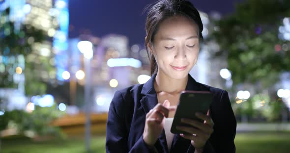 Businesswoman use of cellphone in Hong Kong city 