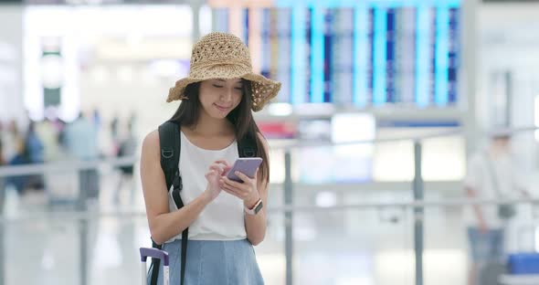 Woman use of mobile phone in the airport