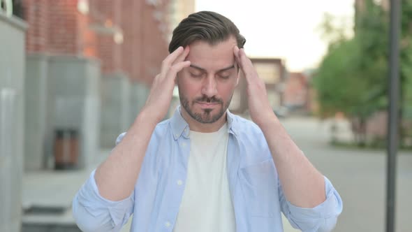 Man Having Headache While Standing Outdoor