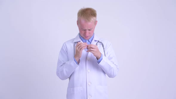 Stressed Young Blonde Man Doctor Having Headache