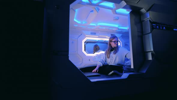 Young Lady Opens a Door of a Capsule Room From Inside