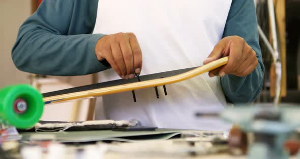 Man making skateboard 