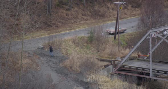 Helicopter aerial shot above river in industrial landscape, cloudy day