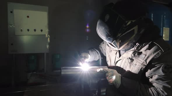 A Production Worker Welds Metal Structures By Argon Welding