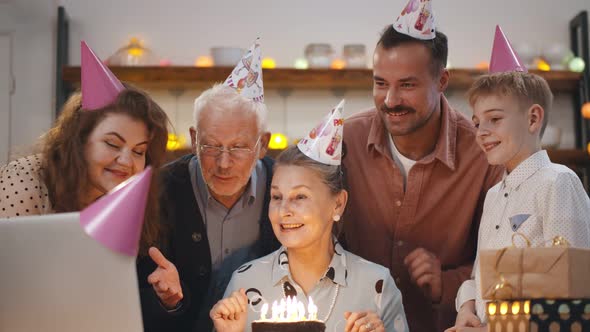 Happy Family Celebrating Senior Woman Together Having Video Call with Friends