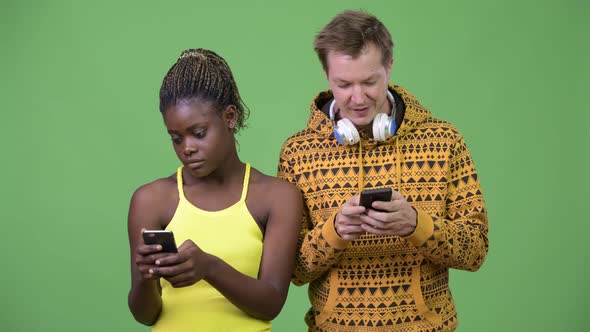 Young Multi-ethnic Couple Using Phone Together