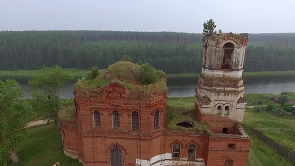 Aerial view of Old ruined abandoned church in a village on the banks of the River 01