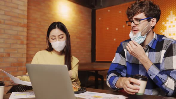 young asian woman and caucasian man Business people Working discuss finding new strategy