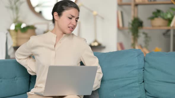 Laptop Work By Indian Woman with Back Pain on Sofa 