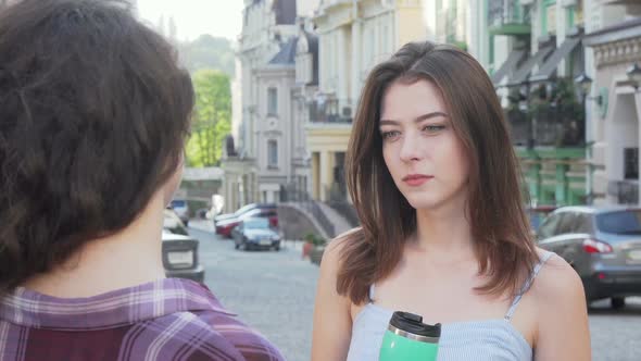 Charming Woman Comforting Her Upset Friend While Talking Outdoors