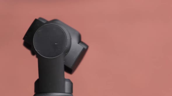 Mechanical Gimbal Camera Lens Rotates on Red Background Robotic Camera Macro