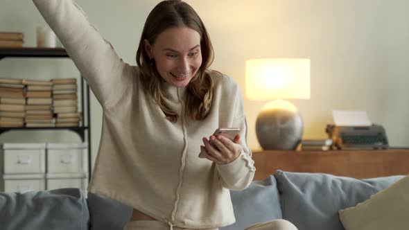 Woman Getting Good News Notification Via Mobile Phone