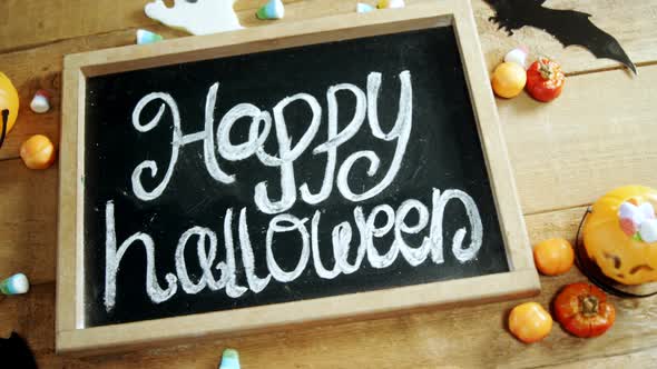 Happy halloween text written on a slate 4k