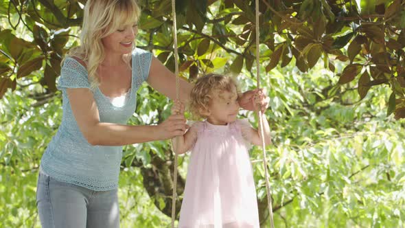 Spring and happy summer time. joyful and smiling mother with her blue eyed little girl daughter chil