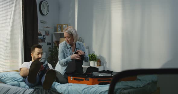 Couple Packing in Bedroom