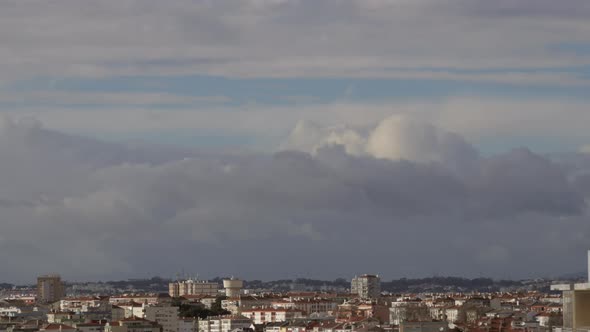 Motion Timelapse Of Clouds Over An Urban City On A Sunny Day - wide shot