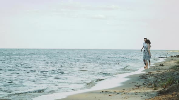 Happy Couple Together Running Through the Beach Side They Feeling Great and Very Romantic Holding