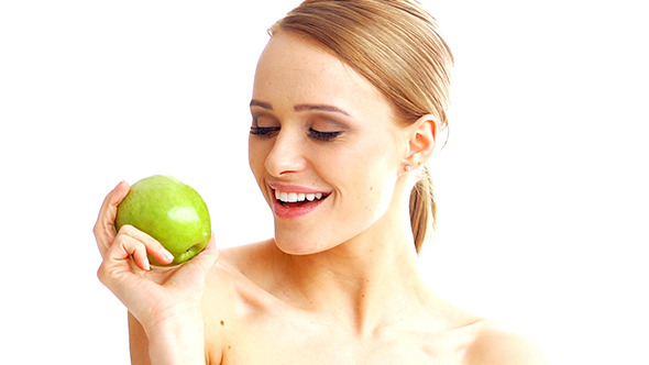 Blond Cute Girl Showing Green Fresh Apple