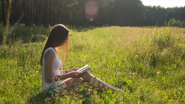 Beautiful Girl Reading a Book in Nature