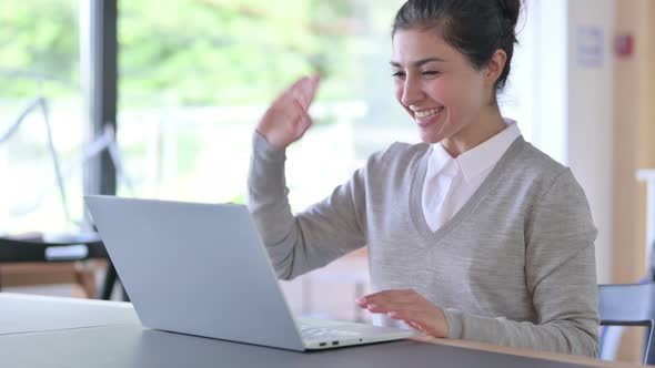 Indian Woman Doing Video Chat on Laptop at Work 