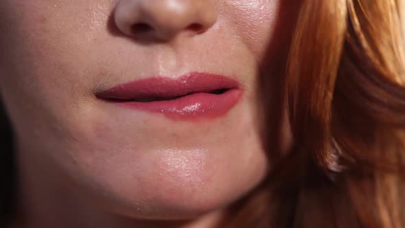 Close Up Shot of the Lips of a Woman Who Eroticly Bites the Bottom of the Lip