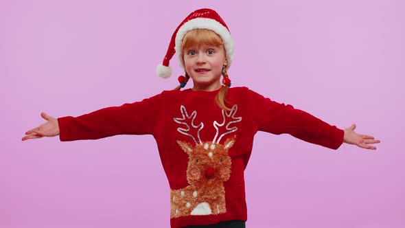 Child Girl Kid in Christmas Sweater Raising Hands in Surprise Shocked By Sudden Victory Wow Emotion