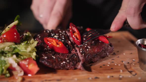 juicy piece of beef ready-made steak on a fork