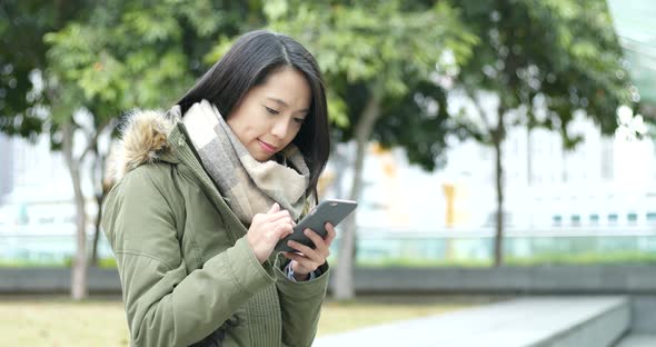 Woman use of mobile phone in the city