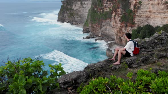 Guy Sits on Edge of Cliff, Young Boy Coming To Edge of Cliff and Sitting Down, Man Sitting 