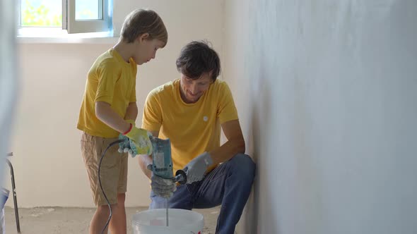 A Young Man and His Son are Doing a Walls Renovation in Their Home