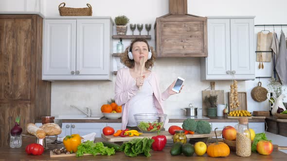 Happy Lifestyle, Pregnancy And Technology Concept. Cheerful Pregnant Girl Dancing On Kitchen