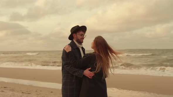 Young Couple in Love Spinning on the Sea