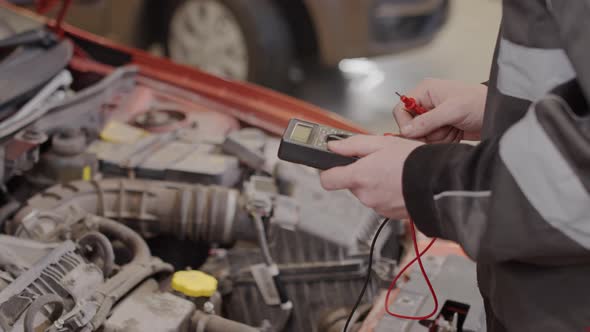 Mechanic Doing Auto Diagnostic with Car Code Reader