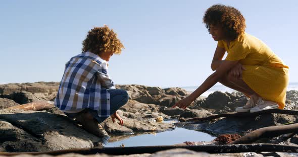 Mother and son having fun together at beach 