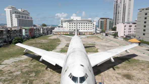 Aerial of Abandoned Boeing Plane Jumbo Jet in the middle of a city on a sunny day. Drone Shot 4k