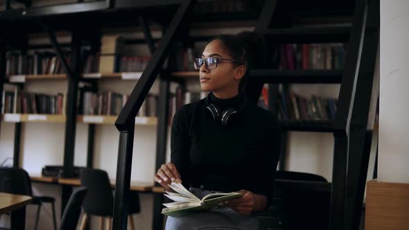 Intelligent Afro American Student Collecting Information From Different Books Stylish Girl in Black
