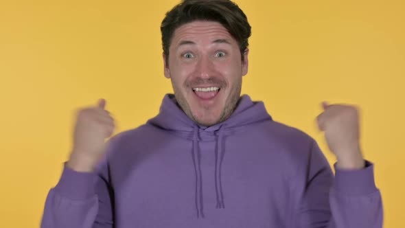 Excited Man Celebrating Yellow Background