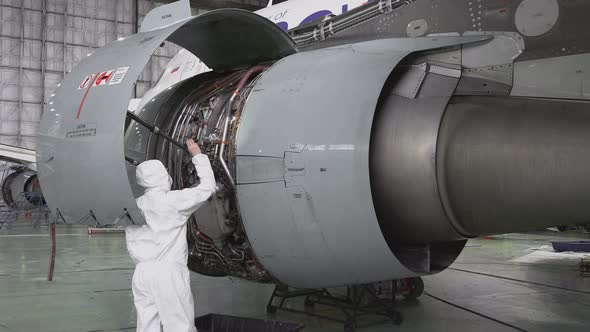 Master repairs the engine of a passenger aircraft 