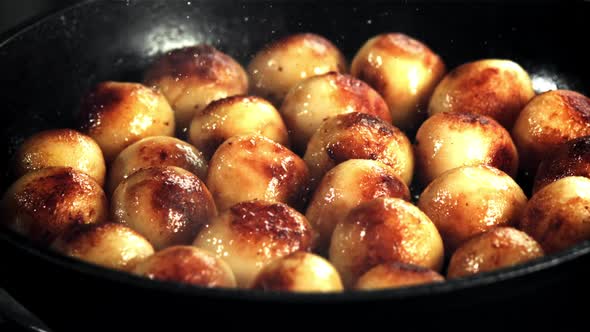 Potatoes are Fried in a Frying Pan with Splashes of Oil and Hot Steam