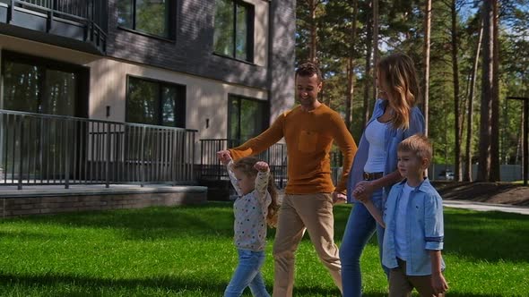 Family with Kids Walking at Park Near Home