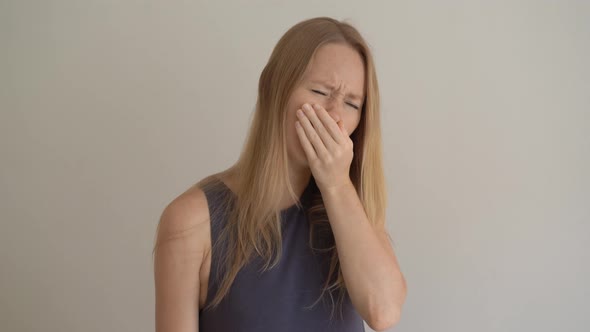 A Young Woman Sneezes Improperly