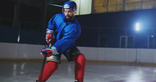 Professional Hockey Player Attacks the Gate and Strikes, but the Goalkeeper Beats the Puck. A Goal