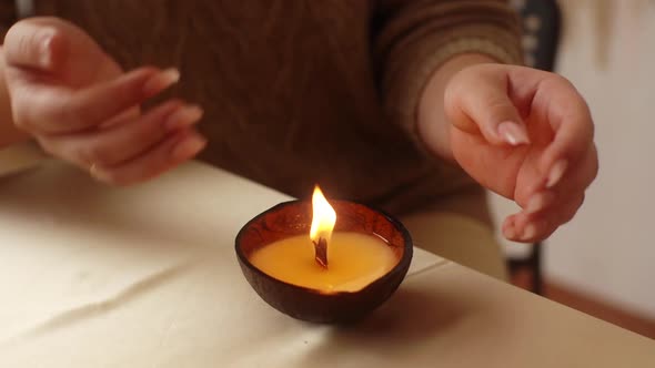 Closeup Cropped Shot of Unrecognizable Woman Spreading Melted Wax From Burning Handmade Candle on