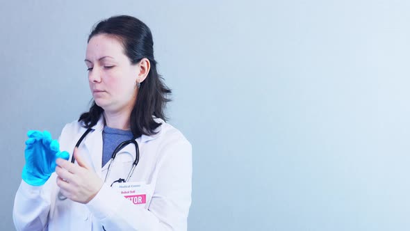 Portrait Brunette Female Doctor Taking Off Blue Protective Latex Gloves Isolated