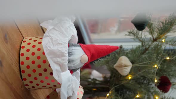 Christmas Gnome in Gift Box on Window Sill at Home