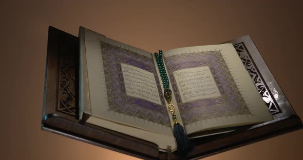 Holy Quran On Book Rest With Prayer Beads