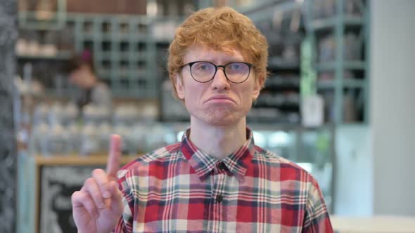 Young Redhead Man Showing No Sign with Finger