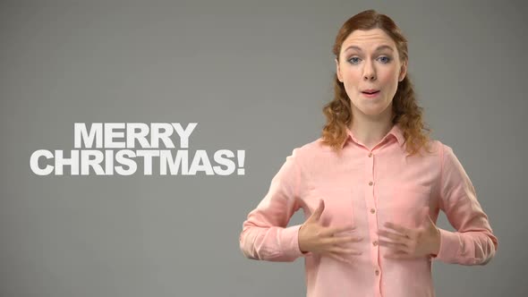 Deaf Lady Saying Merry Christmas in Sign Language, Text on Background, Deafness