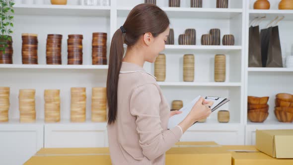 Portrait of Asian beautiful woman selling vase product online at home.